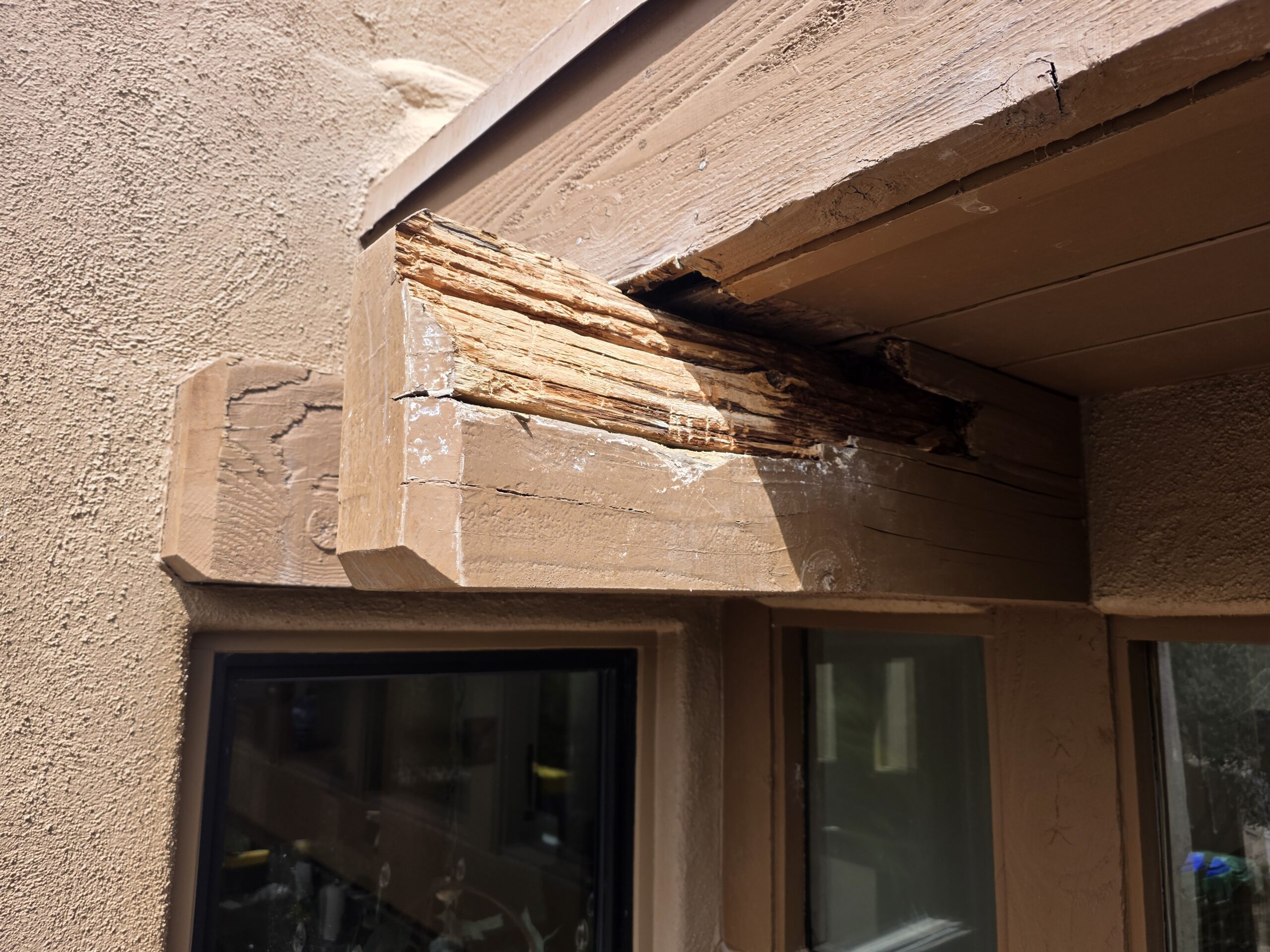 Weathered exposed beam end with Arizona sun and moisture damage