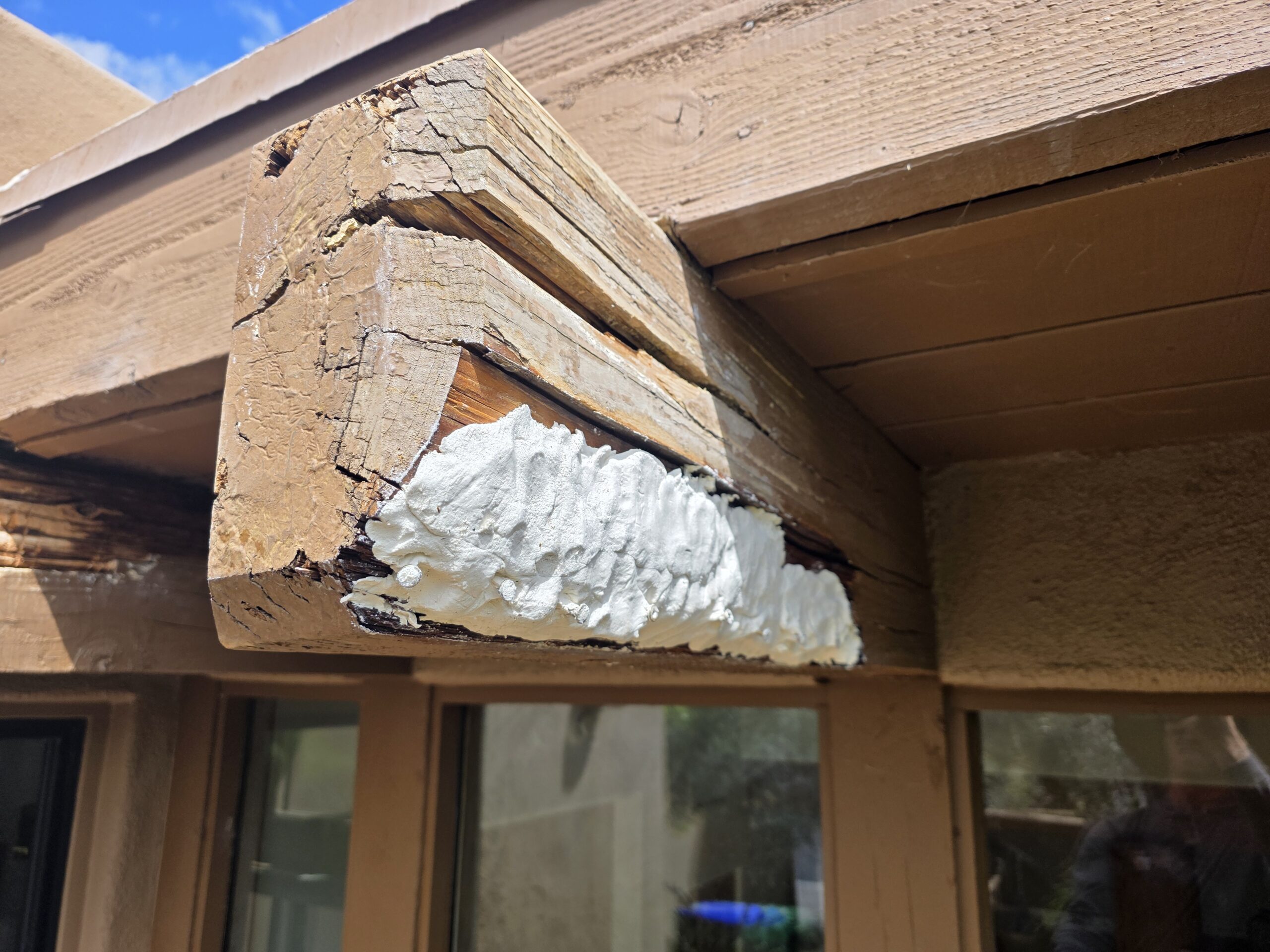 Epoxy beam restoration in progress on a damaged exposed beam end