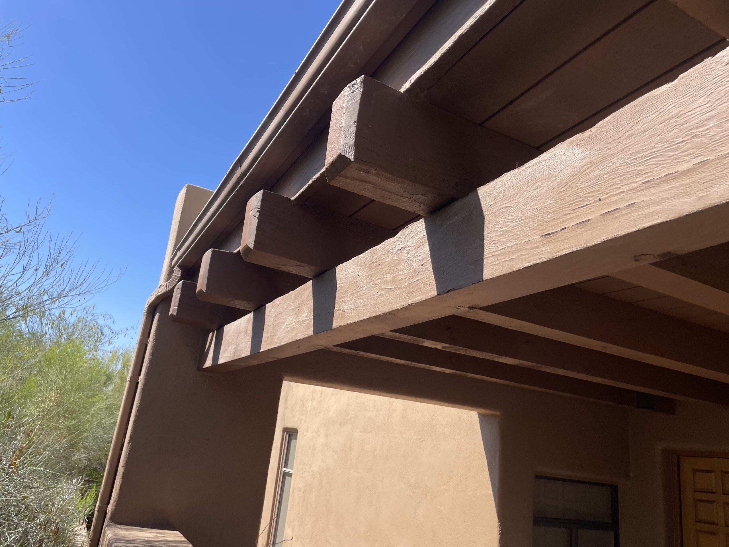 Rotted exposed beam end before repair on an Arizona home
