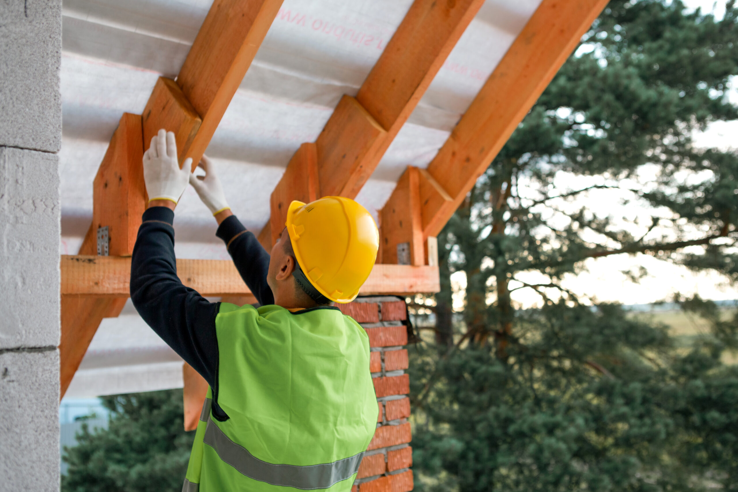 Viga Beam Repair for Southwestern Homes Construction worker repairing exposed roof beams on an Arizona home