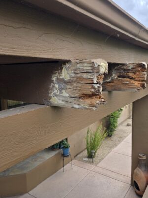 Severely deteriorated exposed wood beam end before repair on a Phoenix-area home