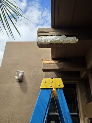 Damaged exterior wood beam being prepared for beam end restoration